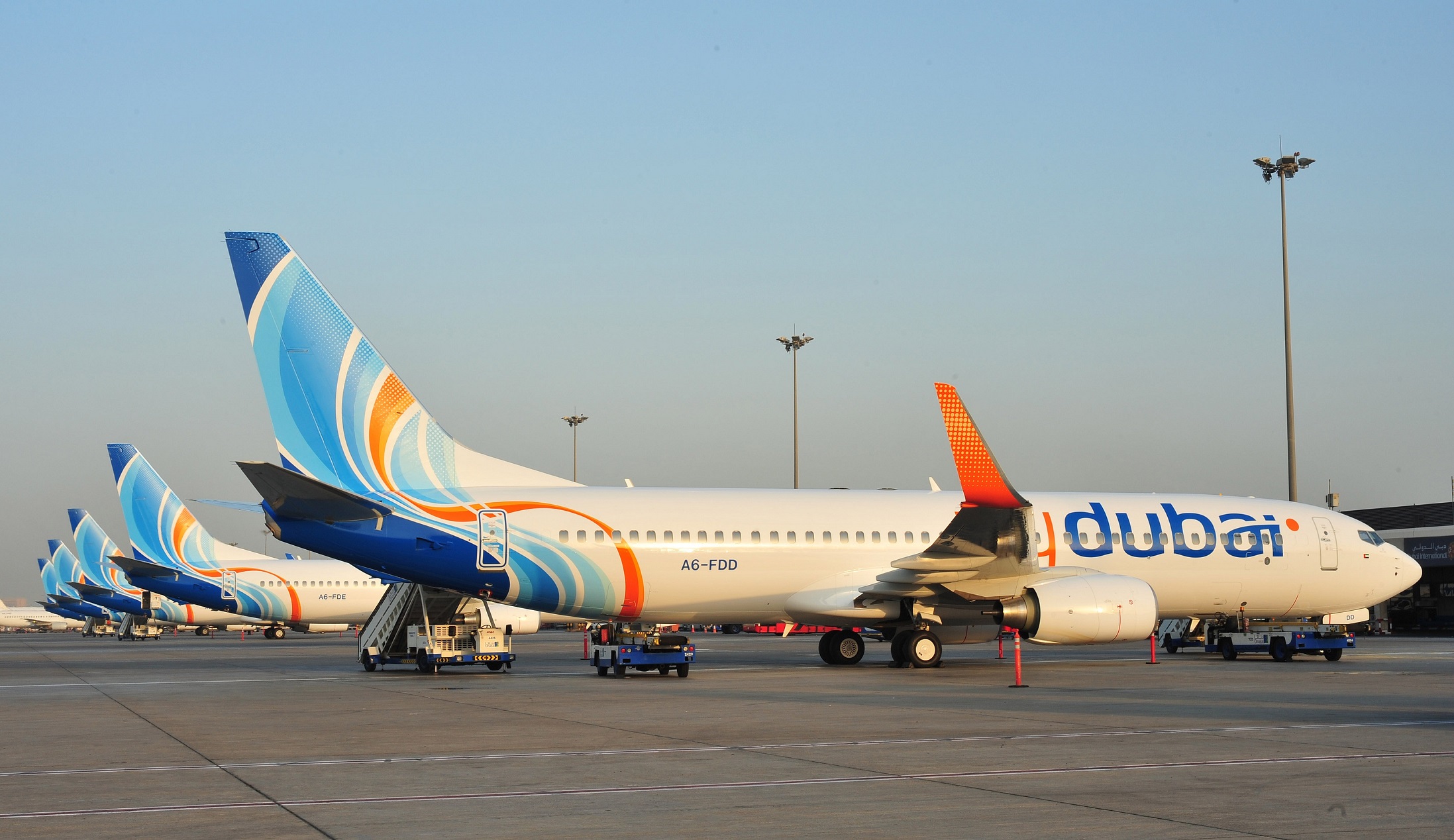 flydubai Boeing 737-800 on stand with ground handling equipment at Dubai
